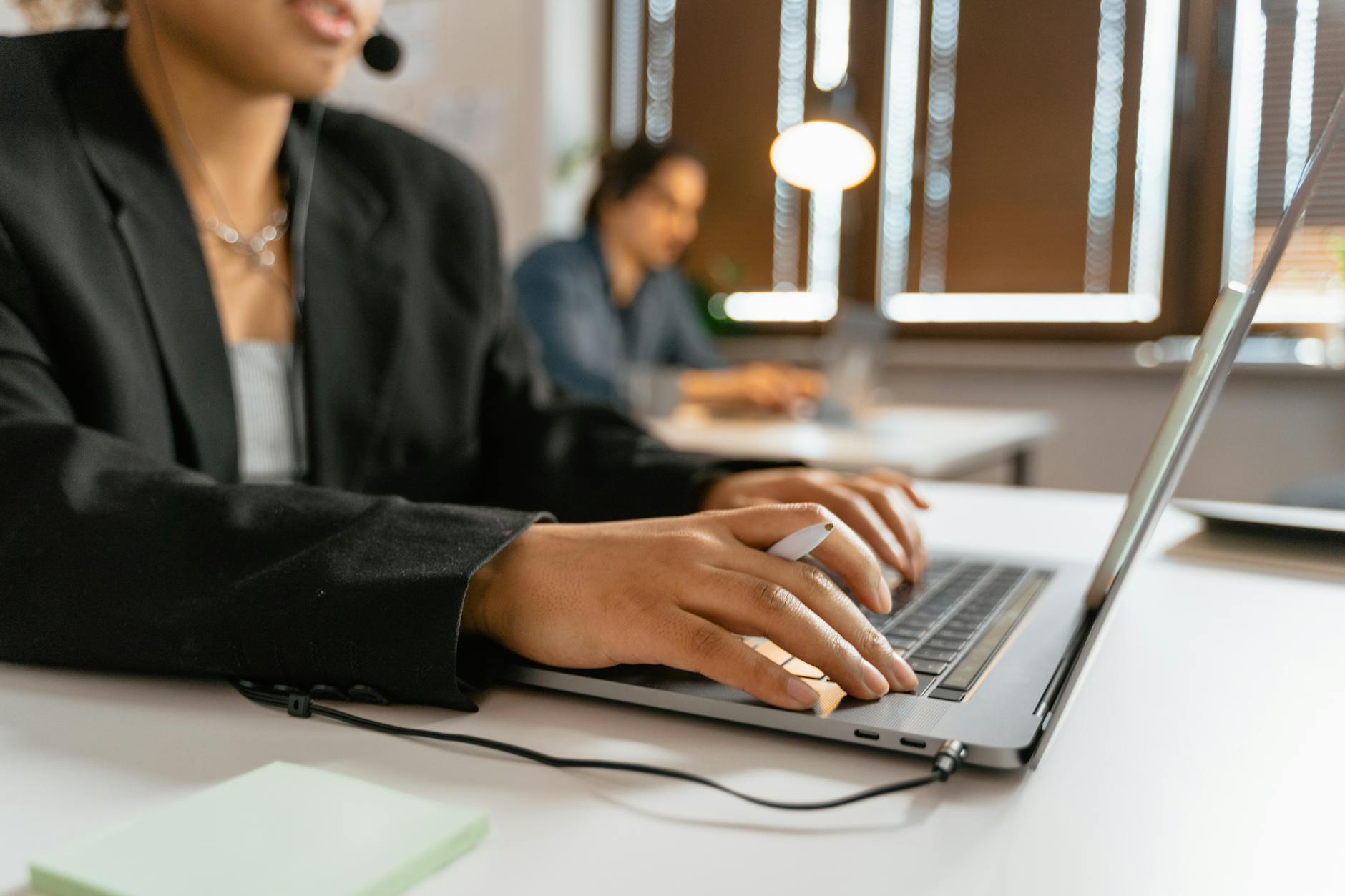 AI agent productivity workflow with team members using laptops in an office