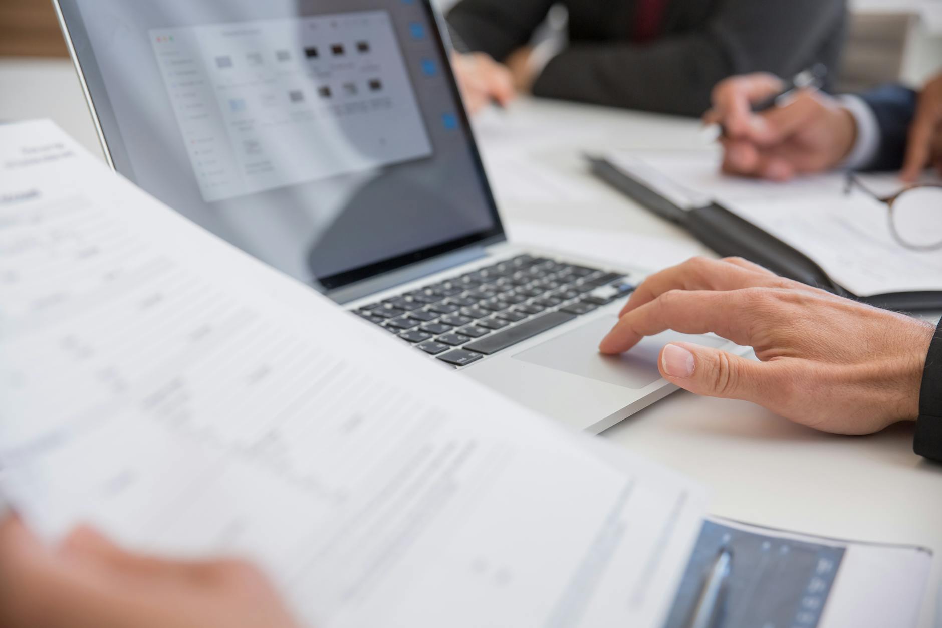 Documents and laptop workspace for uploading PDFs images and docs into analysis